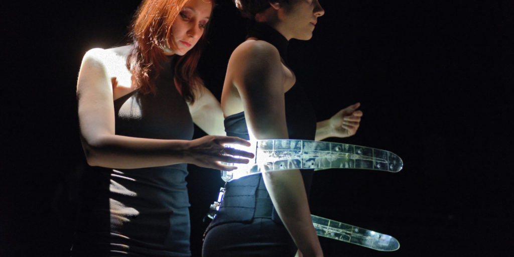 The Prosthetic Ribs have touch-sensitive panels along their length. Here Marjolaine Lambert plays the Ribs while they are worn by Sophie Breton. Photo ©Michael Slobodian.